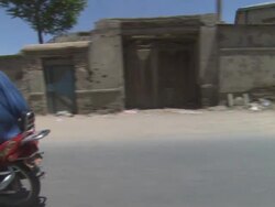 WS POV Car on street passing by vehicles and houses in dusty village / Kabul, Kabul, Afghanistan Stock Footage
