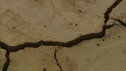 Cracks criss-cross over a dry lake bed. Stock Footage