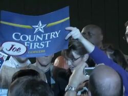 October 2009 MS ZI Republican vice-presidential candidate, Sarah Palin, with her husband Todd Palin greeting supporters and holding young girl during presidential campaign/ York, Pennsylvania, USA/ AUDIO Stock Footage