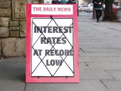 Newspaper headline board - Interest rates at record low Stock Footage