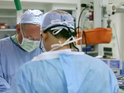 Doctors performing surgery in operating room Stock Footage