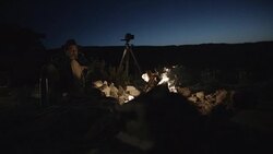 Middle-Aged Caucasian Male Sits by Campfire Stock Footage