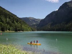 WS Mountain landscape with lake and family in canoe/ French Alps Stock Footage