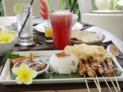 MS Shot of Chicken Sate, Fried Chicken skewer with steamed rice, Kerupuk crackers and Watermelon juice / Ubud, Bali, Indonesia Stock Footage