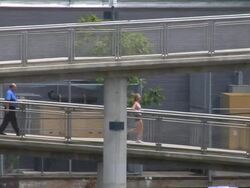 Female runner on a footbridge Stock Footage