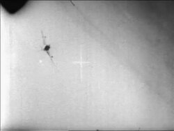 B/W 1967 military aircraft point of view thru crosshairs of MIG exploding in Six Day War / newsreel Stock Footage