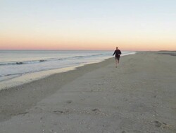 WS Mature man running on beach side / Clinton, New Jersey, USA Stock Footage