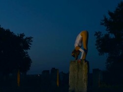 Acrobat Girl on column at night Stock Footage