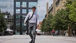 SLO MO Yuppie skateboarding in the city Stock Footage
