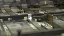 A machine processes newly printed US dollar bills. Stock Footage