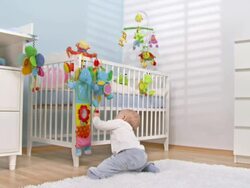HD CRANE: Baby Exploring Crib Toys Stock Footage