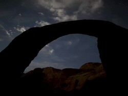 MS T/L Rock formation against night to day sky with clouds and stars / Page, Arizona, United States Stock Footage