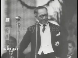 1942: JAPANESE OCCUPIED PHILIPPINES: PAN Crowd holding Japanese flags & multi-language banners, President of Japanese Republic of Philippines Jose Laurel speaking behind microphone, HA WS Crowd cheering in front of large gazebo. Collaboration, WWII. Instructional Video
