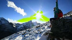 Young hiker sitting on rock, arms outstretched Stock Footage