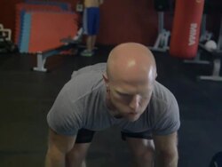 Close-up. Dustin psyches himself up and performs a set of thrusters. Stock Footage