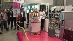 Robotic secretaries and mini chefs among robots on show in Tokyo News Clip