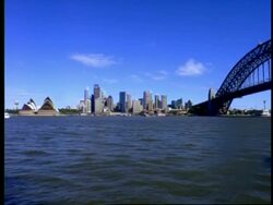 WA view across harbour to Sydney Opera House, Circular Quay, city skyline and Sydney Harbour Bridge, Waves rippling in foreground, Sydney, Australia Stock Footage