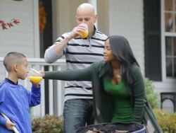 MS PAN Father and son raking leaves and mom brings out cold drinks / Albany, New York, United States Stock Footage