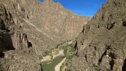 The Rio Grande winds through the steep cliffs of Mariscal Canyon in Big Bend National Park on the border of Texas and Mexico. Stock Footage