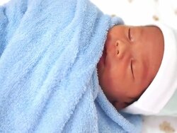 Newborn baby in blue towel Stock Footage