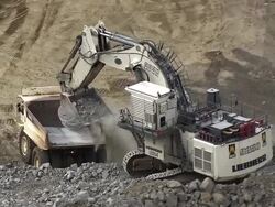 MS AERIAL DS Shot of dump truck being filled with rubble on opencast mine / Johannesburg, Gauteng, South Africa Stock Footage