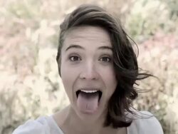 Young woman in grassy field, close up Stock Footage