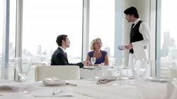 Waiter taking business people's order in restaurant Stock Footage