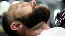 Close-up of beautiful attractive adult man with beard in a barber shop Stock Footage