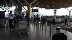 Radio taxis, passengers and airport staff at the entry of the Delhi Airport terminal Stock Footage