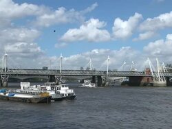 WS Boat passing under Hungerford Bridge in Thames river / London, United Kingdom Stock Footage