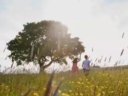 SLO MO Mother and daughter running in the meadow Stock Footage