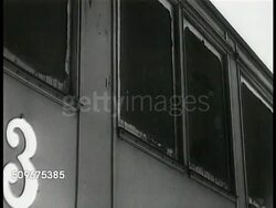 1941: SWEDEN TROOP TRAIN DEAL: Soldier checking under train, Nazi German soldiers watching from window, train begins to move.  WWII, Active neutrality. Instructional Video