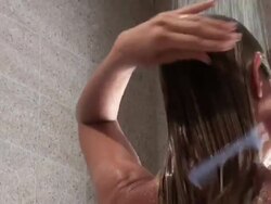 Young woman combing hair while taking her shower Stock Footage