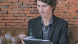 Businessman using credit card for financial transactions online with iPad. Stock Footage