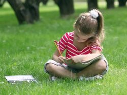 Little girl drawing in park Stock Footage
