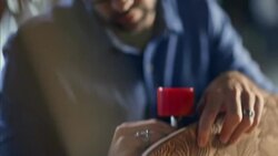 Wood shop worker fastens truck to custom skateboard deck Stock Footage