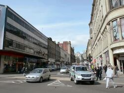 Long shot of traffic junction, pedestrians walking Stock Footage