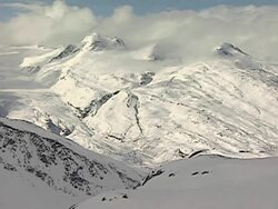Snow covered and cloud enshrouded mountains near Valdez, Alaska Stock Footage