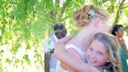 Bride and flower girl hugging at wedding reception Stock Footage
