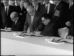 B/W 1963 close up tilt down PROFILE Andrei Gromyko in eyeglasses signing Atomic Test Ban Treaty / newsreel Stock Footage
