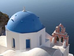 CU Shot of church dome at village Oia with Ocean / Santorini, Cyclades, Greece Stock Footage