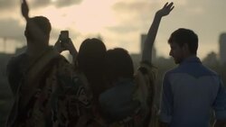 Friends throw hands in the air and take smartphone photos overlooking Austin, Texas skyline Stock Footage