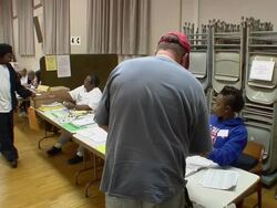 MS, Man signing in at registration table at polling place, Toledo, Ohio, USA Stock Footage