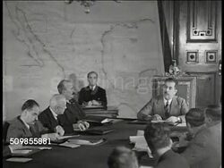 1934: MEXICO PRESIDENT CARDENAS: MS Presidential Palace building. INT WS Mexican President Lazaro Cardenas at head of table w/ officials & men in meeting, map of Mexico on wall BG. MS Cardenas talking. Mexico City Instructional Video