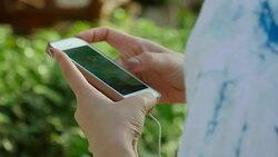Attractive woman listening to music in the park Stock Footage