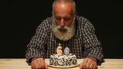 elderly person blows out the candles on the cake Stock Footage