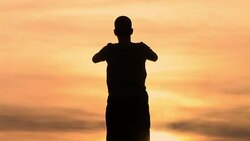 MS, TD, Silhouette of man performing yoga against sky at sunset, rear view, Ljubljana, Slovenia Stock Footage
