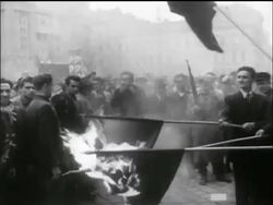 B/W 1956 men hold burning Soviet flags on poles in middle of crowd / Hungarian uprising Stock Footage