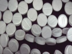 SLOMO CU Wall of paracetamol pills collapsing Stock Footage