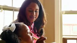 MS Laughing mother eating breakfast with young daughter Stock Footage